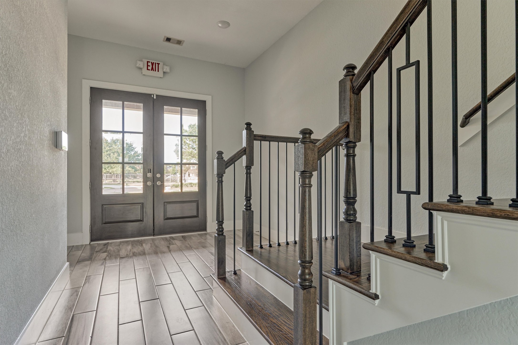 2113 Solstice Boulevard Spring, TX 77386 - Photo 11 of 50 a view of a hallway with wooden floor and staircase