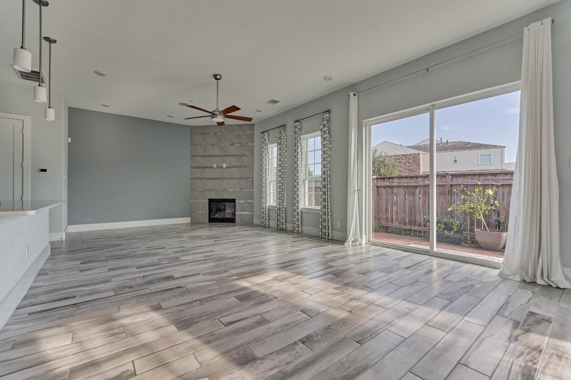 2113 Solstice Boulevard Spring, TX 77386 - Photo 20 of 50 a view of a livingroom with a chandelier a ceiling fan and windows