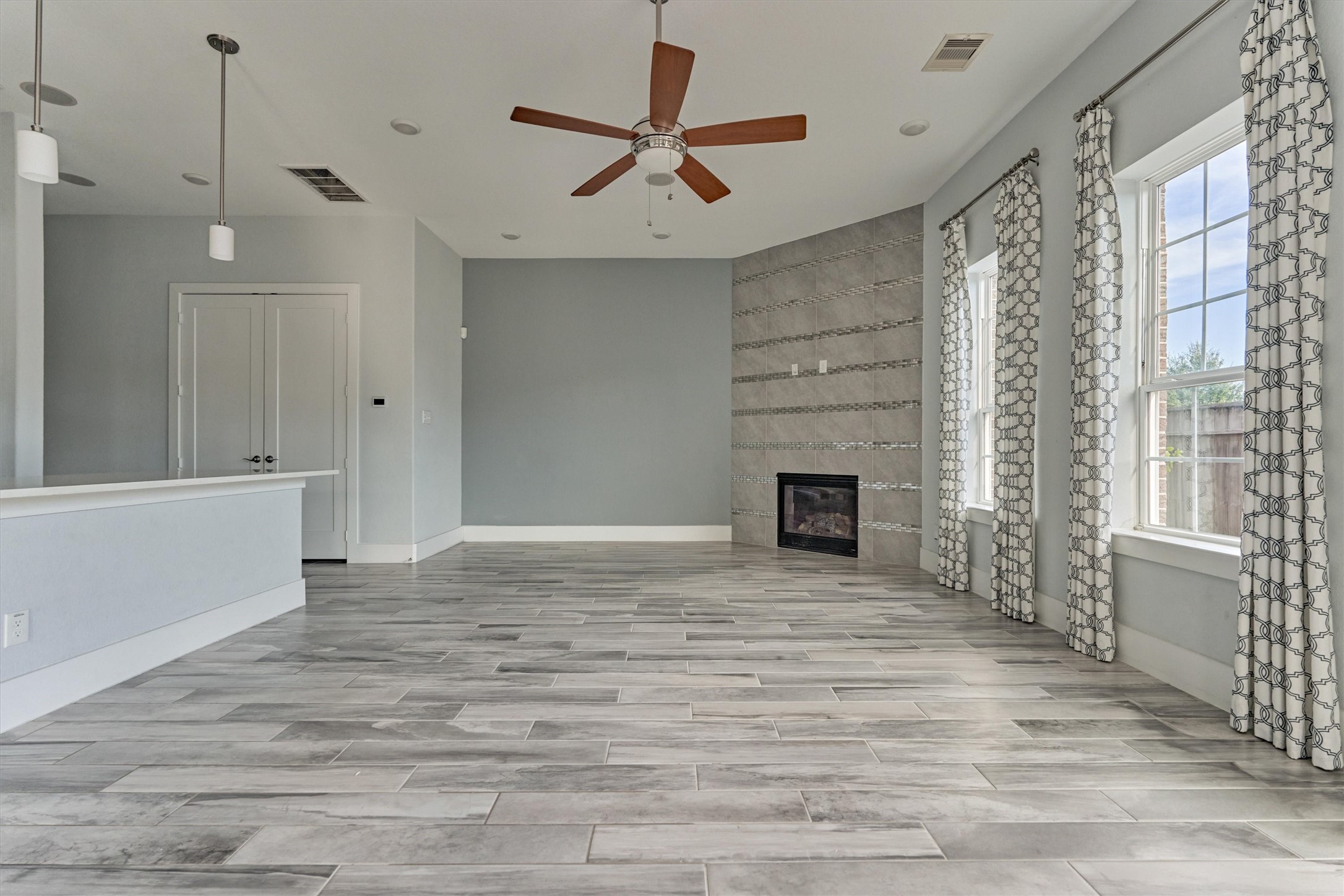 2113 Solstice Boulevard Spring, TX 77386 - Photo 22 of 50 a view of a livingroom with a fireplace a ceiling fan and window