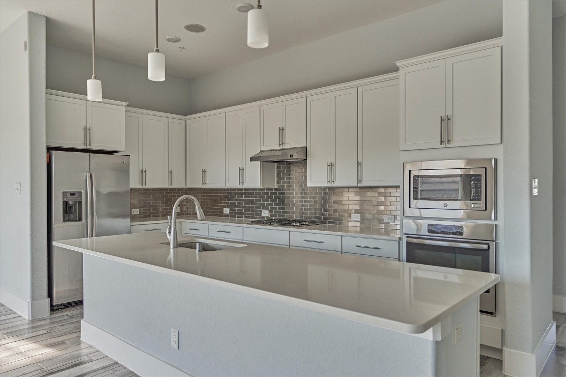 2113 Solstice Boulevard Spring, TX 77386 - Photo 24 of 50 a kitchen with kitchen island a sink stainless steel appliances and cabinets