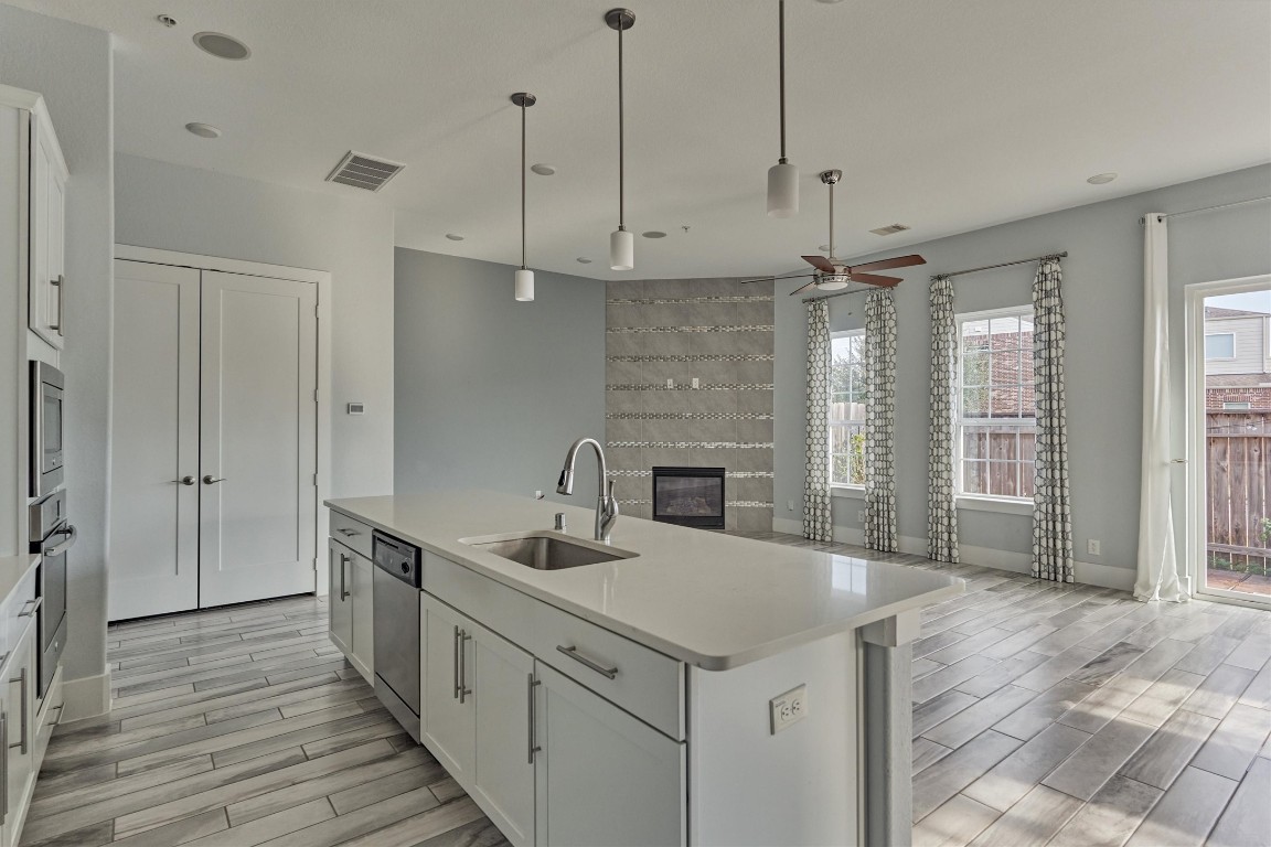 2113 Solstice Boulevard Spring, TX 77386 - Photo 26 of 50 a kitchen with a sink a counter space appliances and cabinets