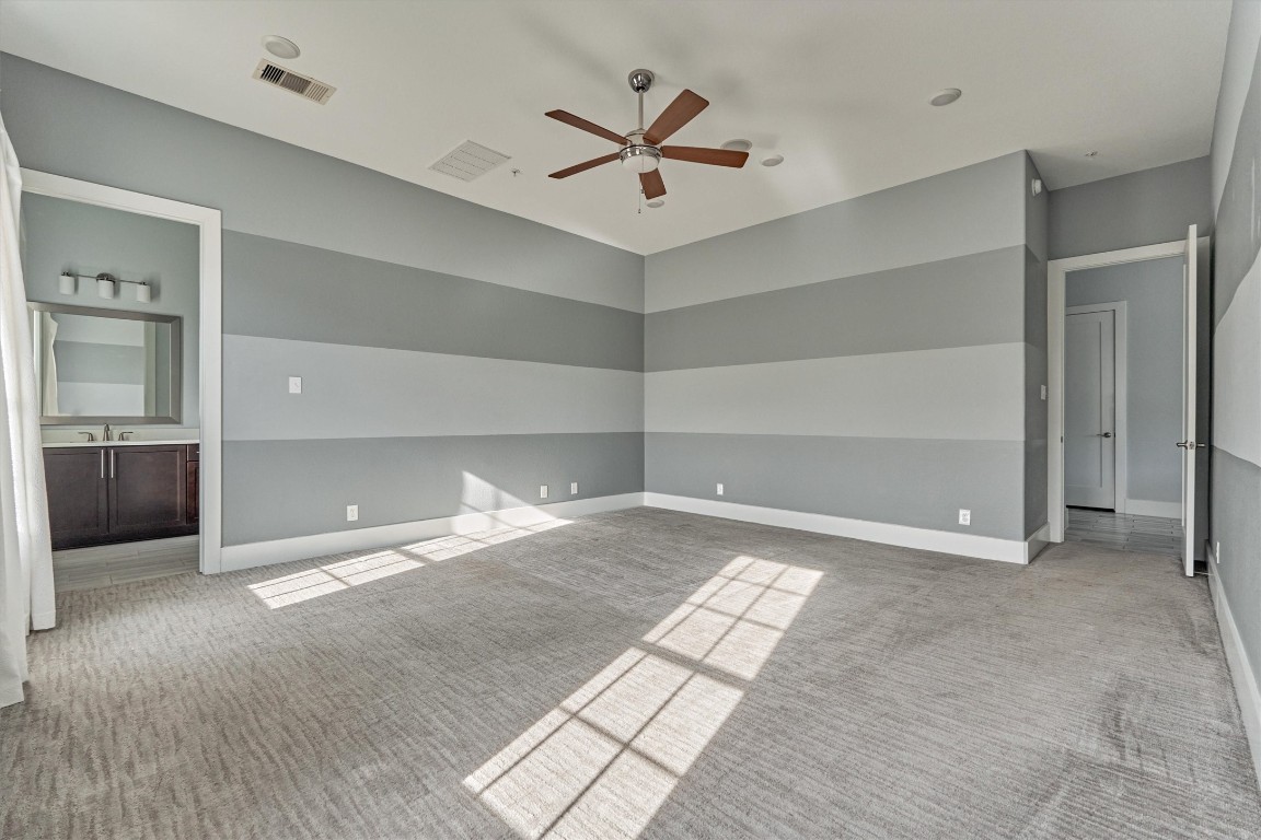 2113 Solstice Boulevard Spring, TX 77386 - Photo 29 of 50 a view of a livingroom with a ceiling fan & kitchen space with a sink