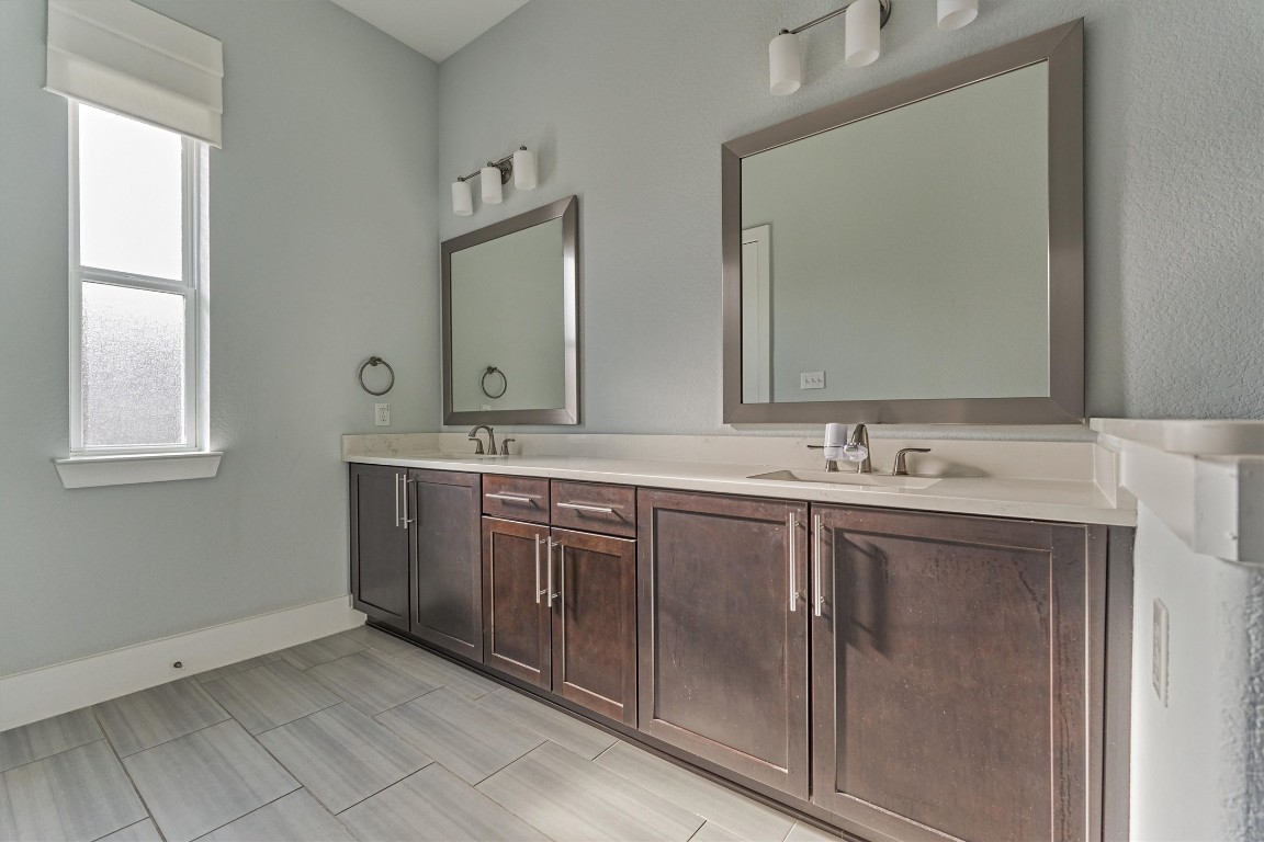 2113 Solstice Boulevard Spring, TX 77386 - Photo 30 of 50 a bathroom with 2 sink and a mirror