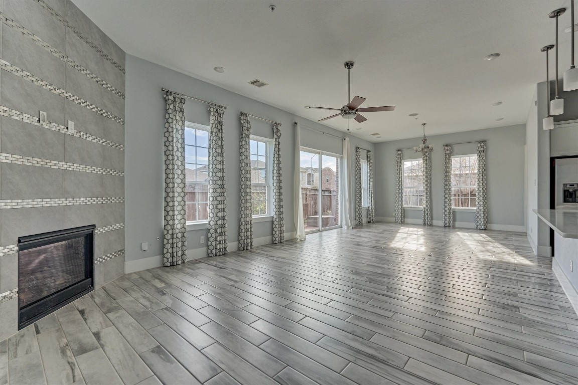 2113 Solstice Boulevard Spring, TX 77386 - Photo 3 of 50 an empty room with wooden floor and a fireplace