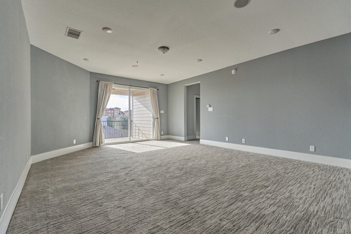 2113 Solstice Boulevard Spring, TX 77386 - Photo 35 of 50 a view of an empty room with wooden floor and a window