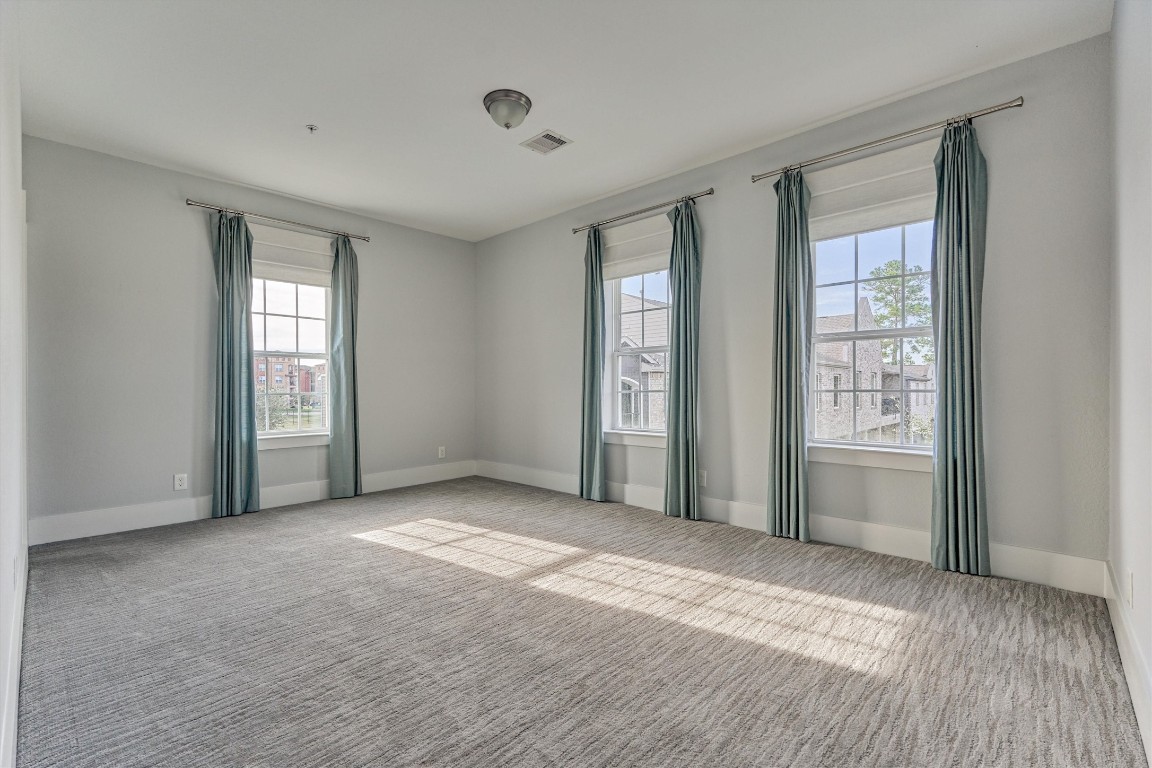 2113 Solstice Boulevard Spring, TX 77386 - Photo 43 of 50 a view of an empty room with a window and wooden floor