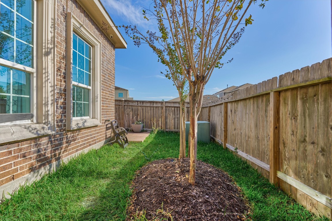 2113 Solstice Boulevard Spring, TX 77386 - Photo 48 of 50 a view of a house with a tree in the grass