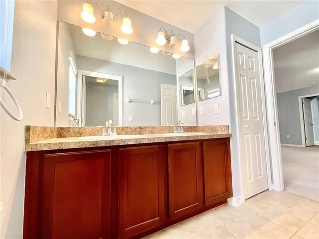 a bathroom with a granite countertop sink mirror and a