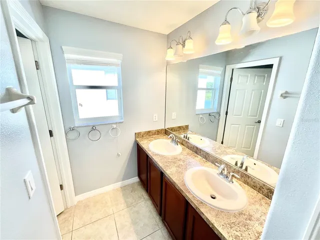 an empty room with windows and ceiling fan