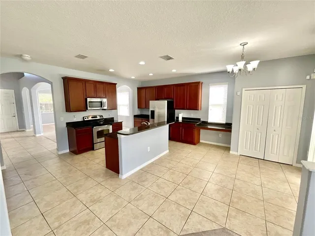 a large kitchen with cabinets and stainless steel appliances