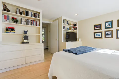 a bedroom with a bed and a book shelf