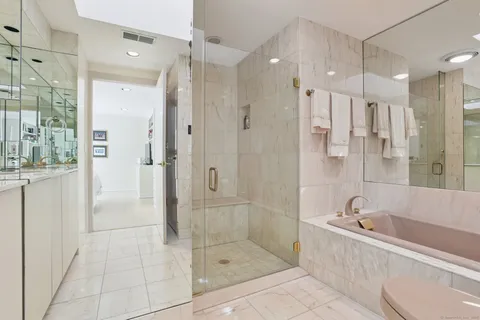 a bathroom with a bathtub shower sink and toilet