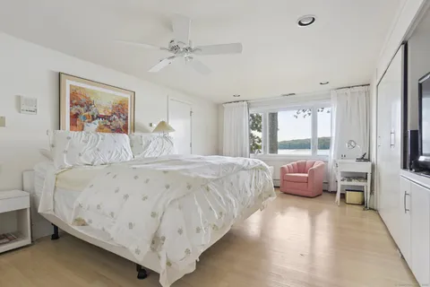 a spacious bedroom with a bed and a large window