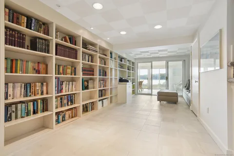 a view of a dining room with furniture large windows and wooden floor