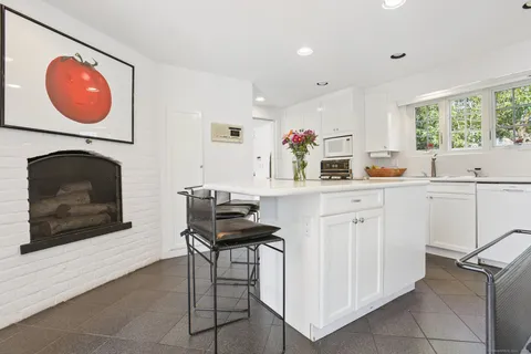 a kitchen with a sink cabinets and window