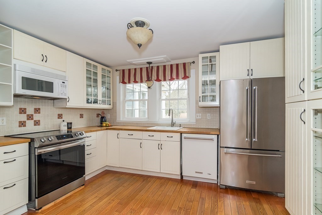 374 Weston Road Wellesley, MA 02482 - Photo 4 of 21 a kitchen with stainless steel appliances a refrigerator sink and cabinets