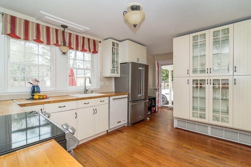374 Weston Road Wellesley, MA 02482 - Photo 10 of 21 a kitchen with a refrigerator a sink and cabinets