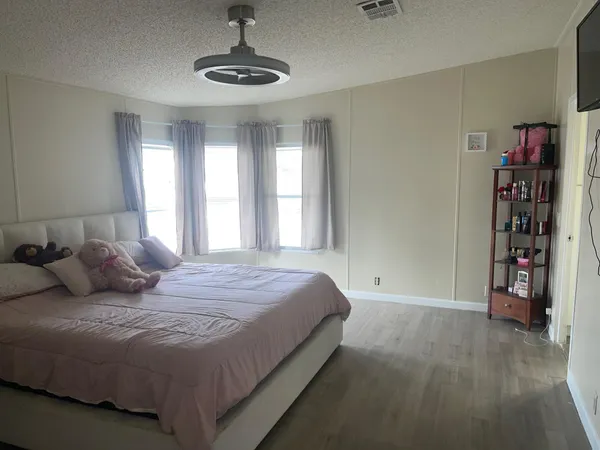 a bedroom with a large bed and a window