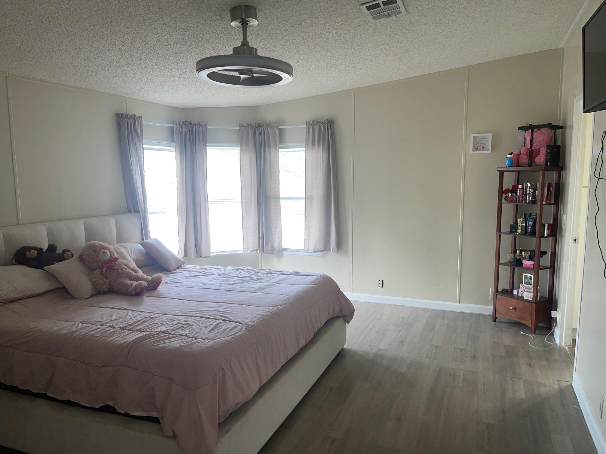 10552 Marina Way Boca Raton, FL 33428 - Photo 11 of 22 a bedroom with a large bed and a window