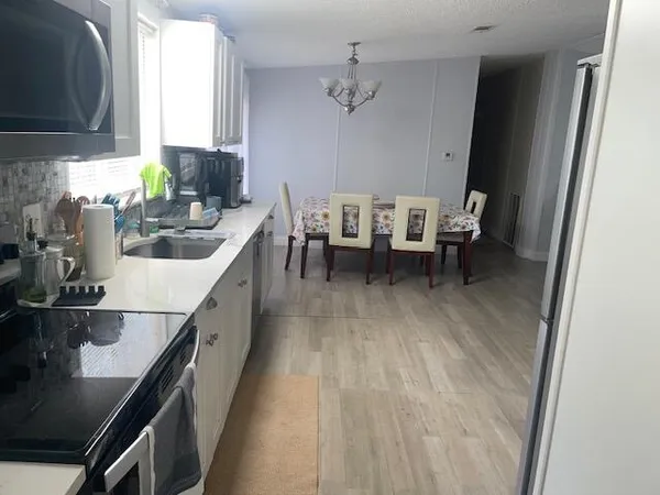 a kitchen with sink cabinets and window