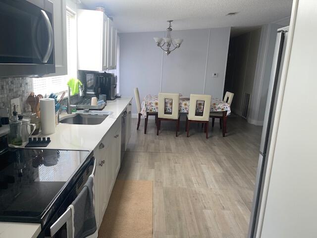 10552 Marina Way Boca Raton, FL 33428 - Photo 14 of 22 a kitchen with sink cabinets and window