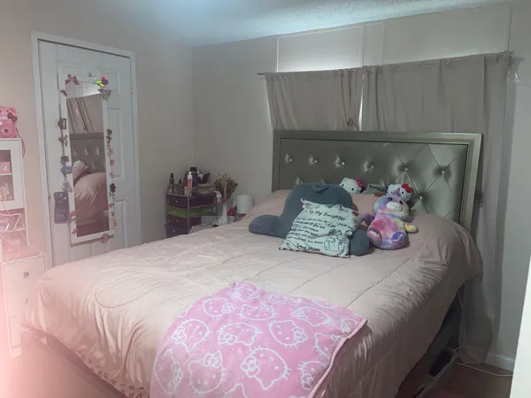 a bedroom with a bed and a potted plant