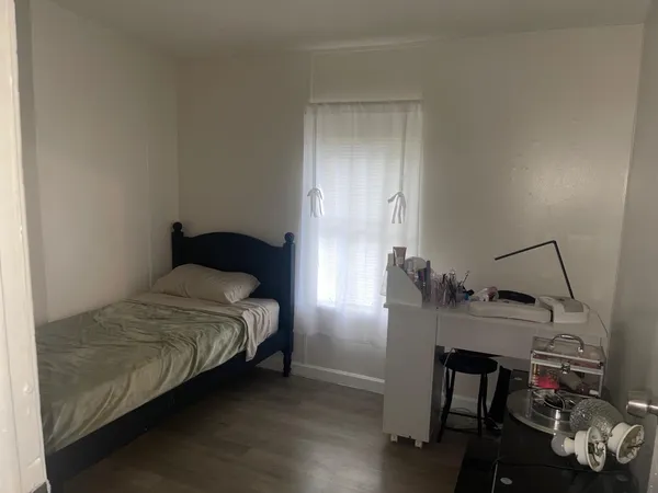 a bedroom with a bed and a table