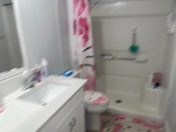 a bathroom with a sink toilet and shower