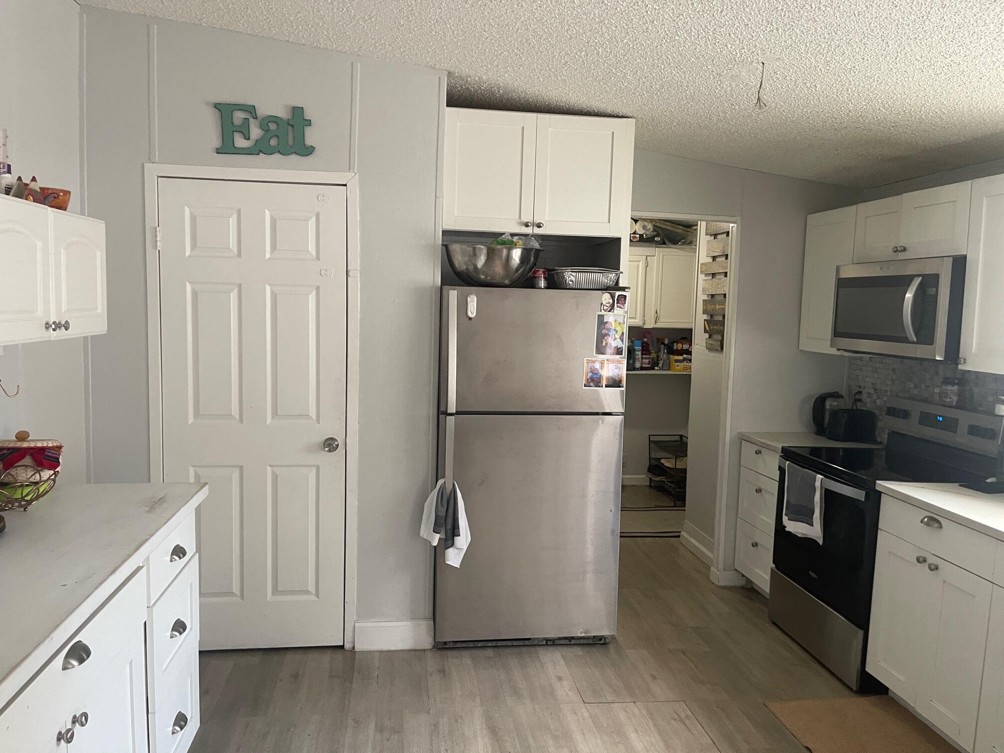 10552 Marina Way Boca Raton, FL 33428 - Photo 6 of 22 a kitchen with cabinets stainless steel appliances and wooden floor