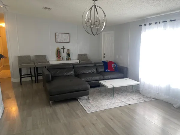 a living room with furniture and a chandelier