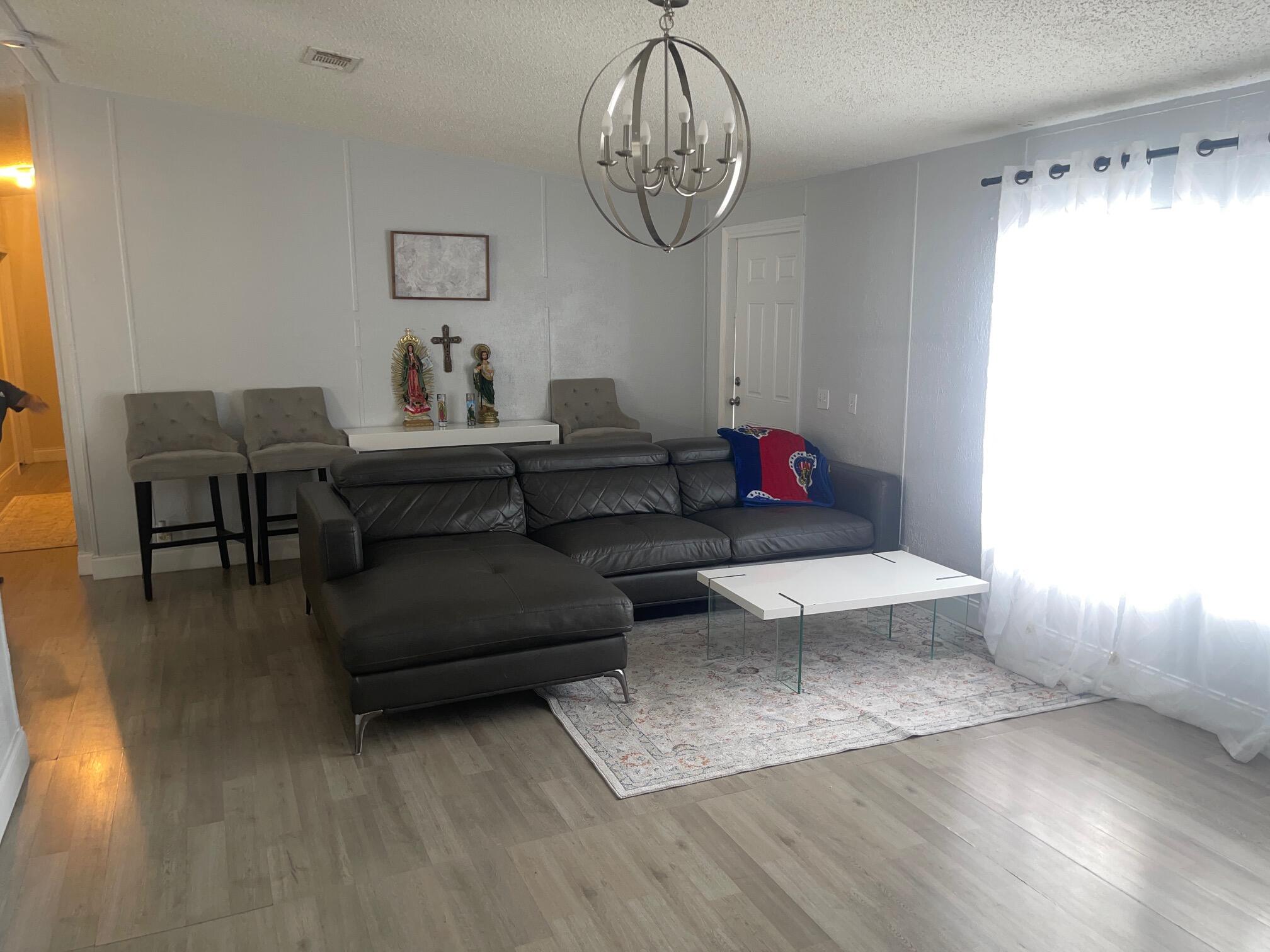 10552 Marina Way Boca Raton, FL 33428 - Photo 8 of 22 a living room with furniture and a chandelier