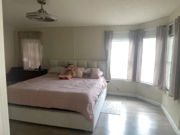 a bedroom with a bed and a window