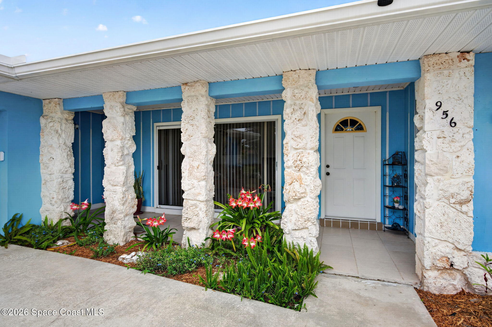 956 Waialae Circle Northeast Palm Bay, FL 32905 - Photo 11 of 45 a front view of a house with flowers