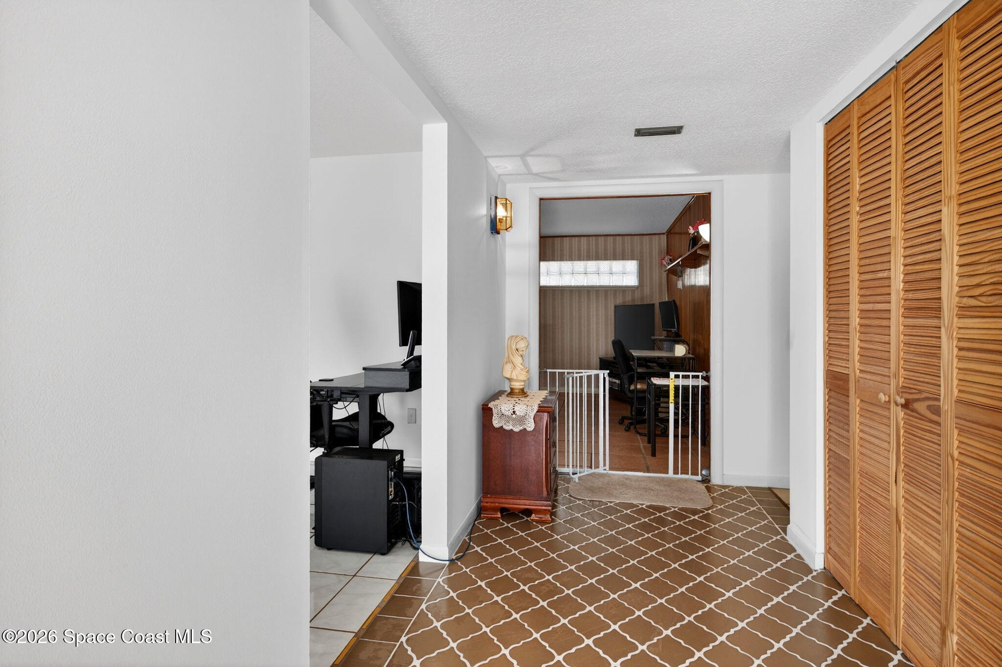 956 Waialae Circle Northeast Palm Bay, FL 32905 - Photo 12 of 45 a view of a hallway with wooden floor and a bathroom