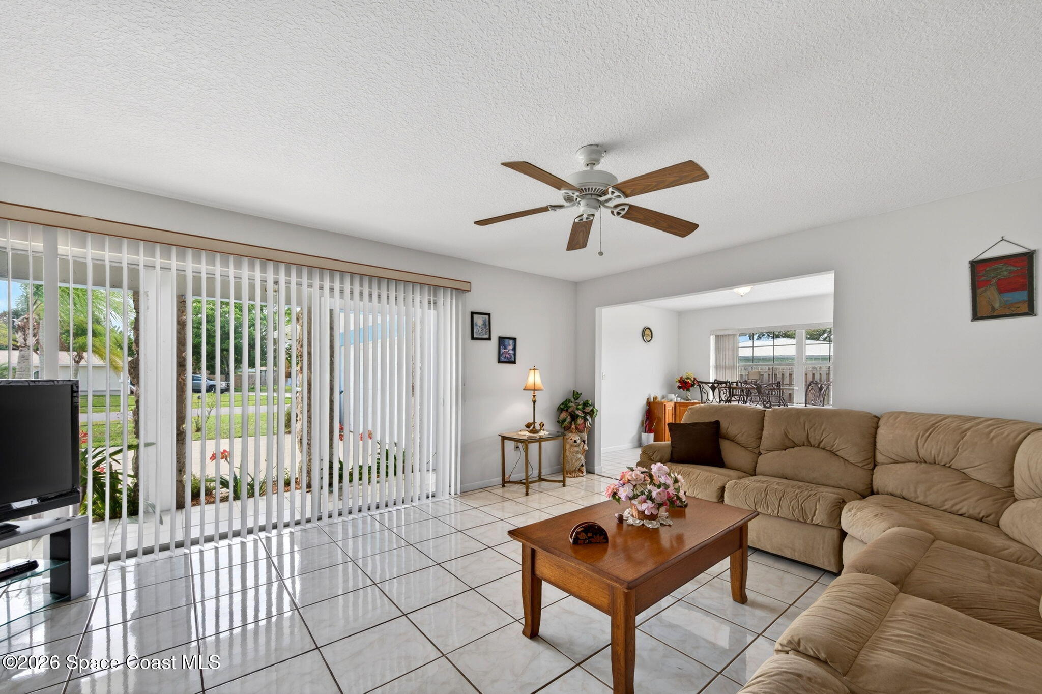 956 Waialae Circle Northeast Palm Bay, FL 32905 - Photo 15 of 45 a living room with furniture and a flat screen tv