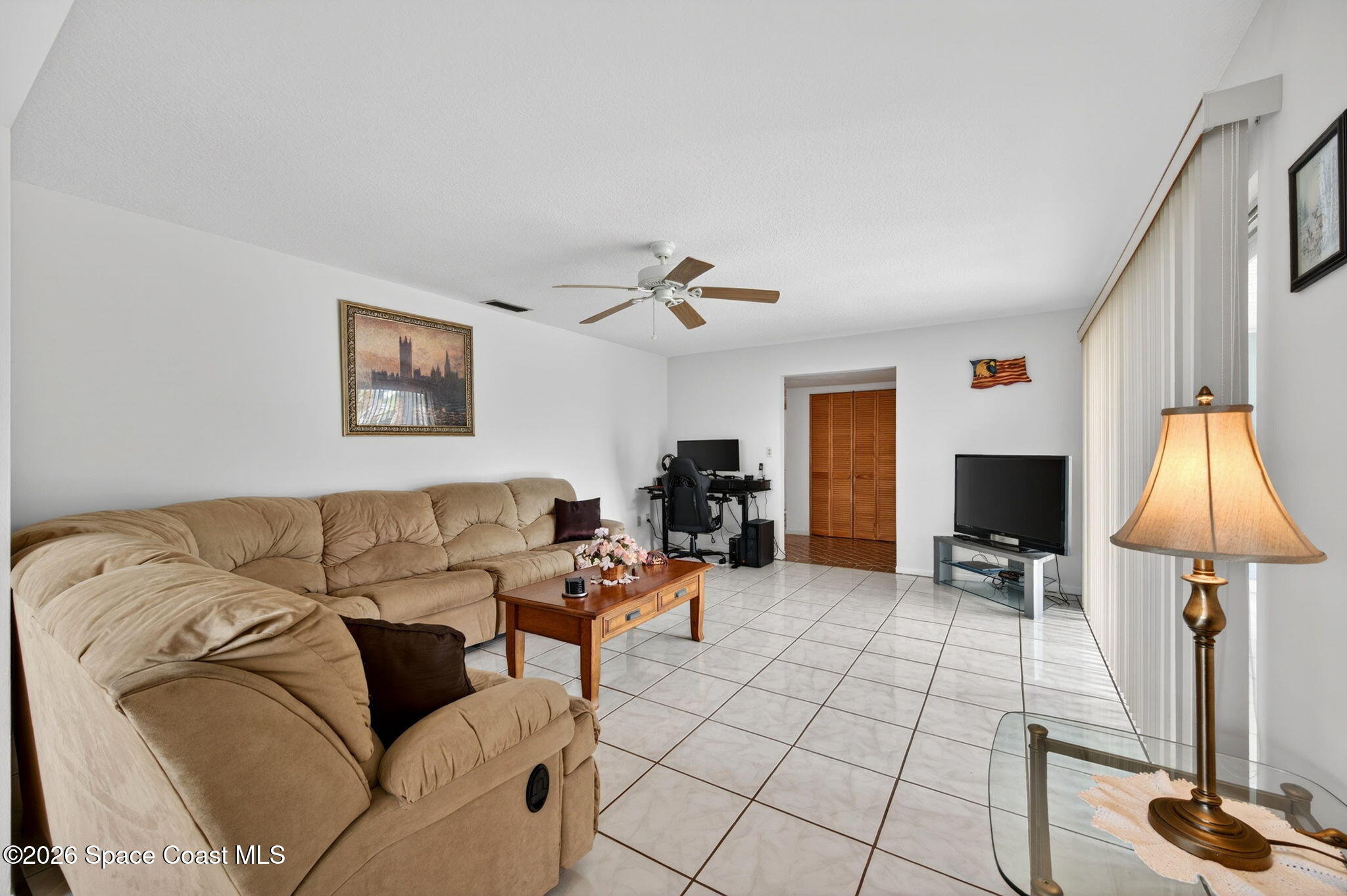 956 Waialae Circle Northeast Palm Bay, FL 32905 - Photo 16 of 45 a living room with furniture and a flat screen tv
