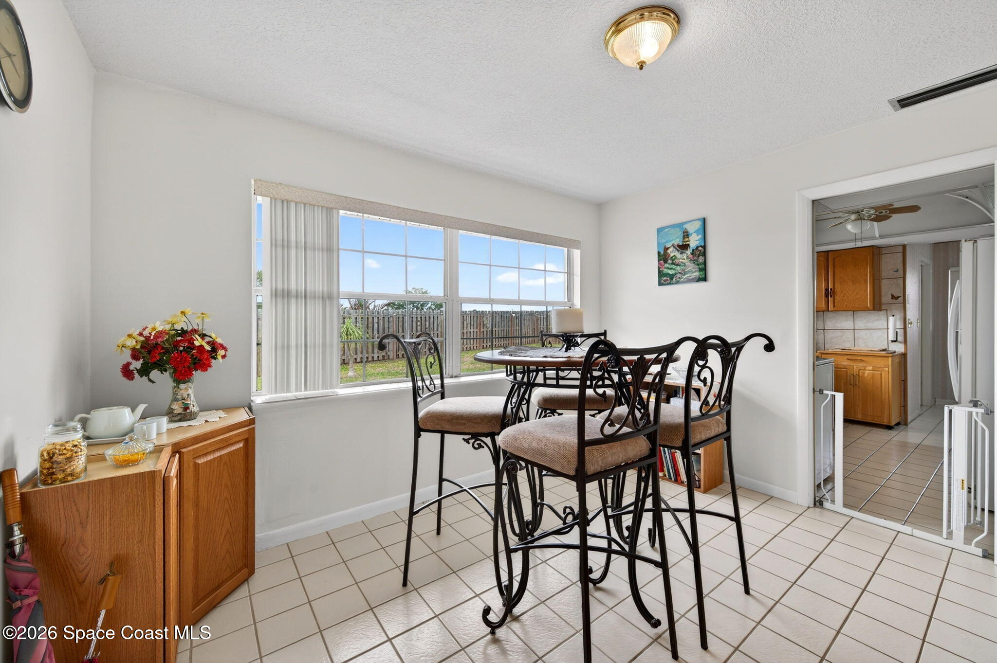 956 Waialae Circle Northeast Palm Bay, FL 32905 - Photo 18 of 45 a dining room with furniture and a window