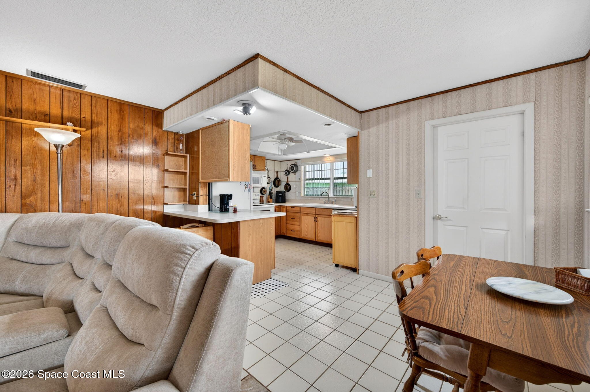 956 Waialae Circle Northeast Palm Bay, FL 32905 - Photo 22 of 45 a living room with furniture and a window