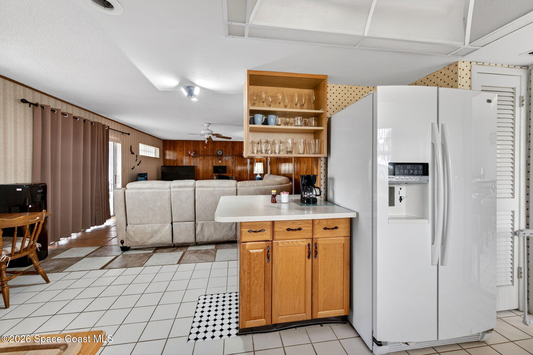 956 Waialae Circle Northeast Palm Bay, FL 32905 - Photo 25 of 45 a kitchen with stainless steel appliances a stove refrigerator and cabinets