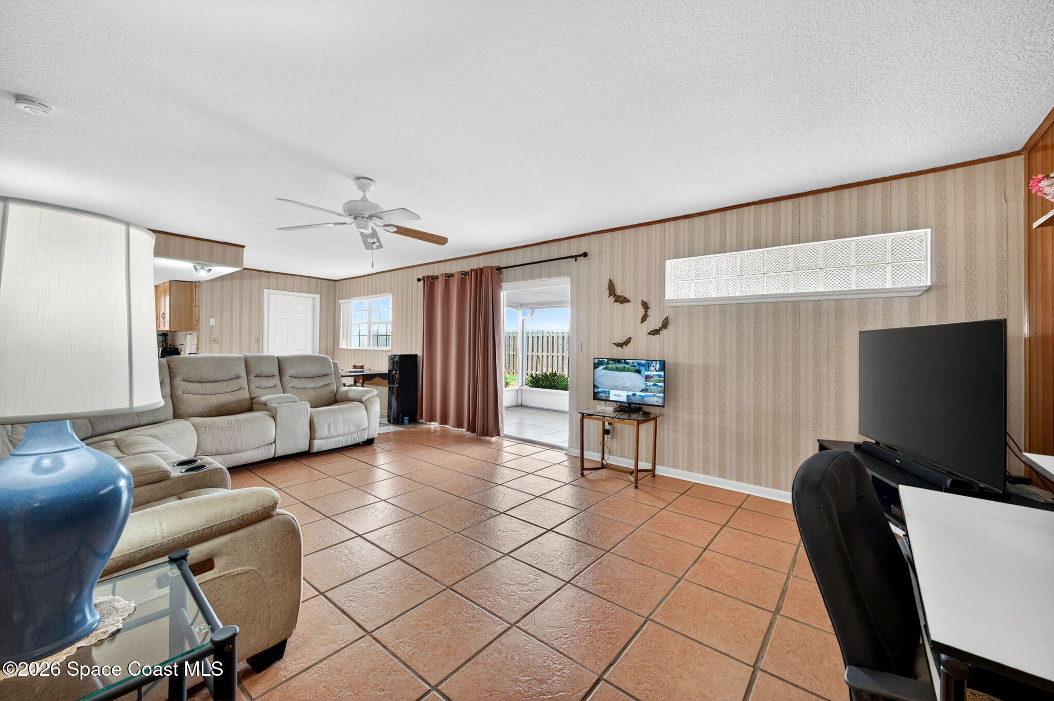956 Waialae Circle Northeast Palm Bay, FL 32905 - Photo 26 of 45 a living room with furniture and a flat screen tv