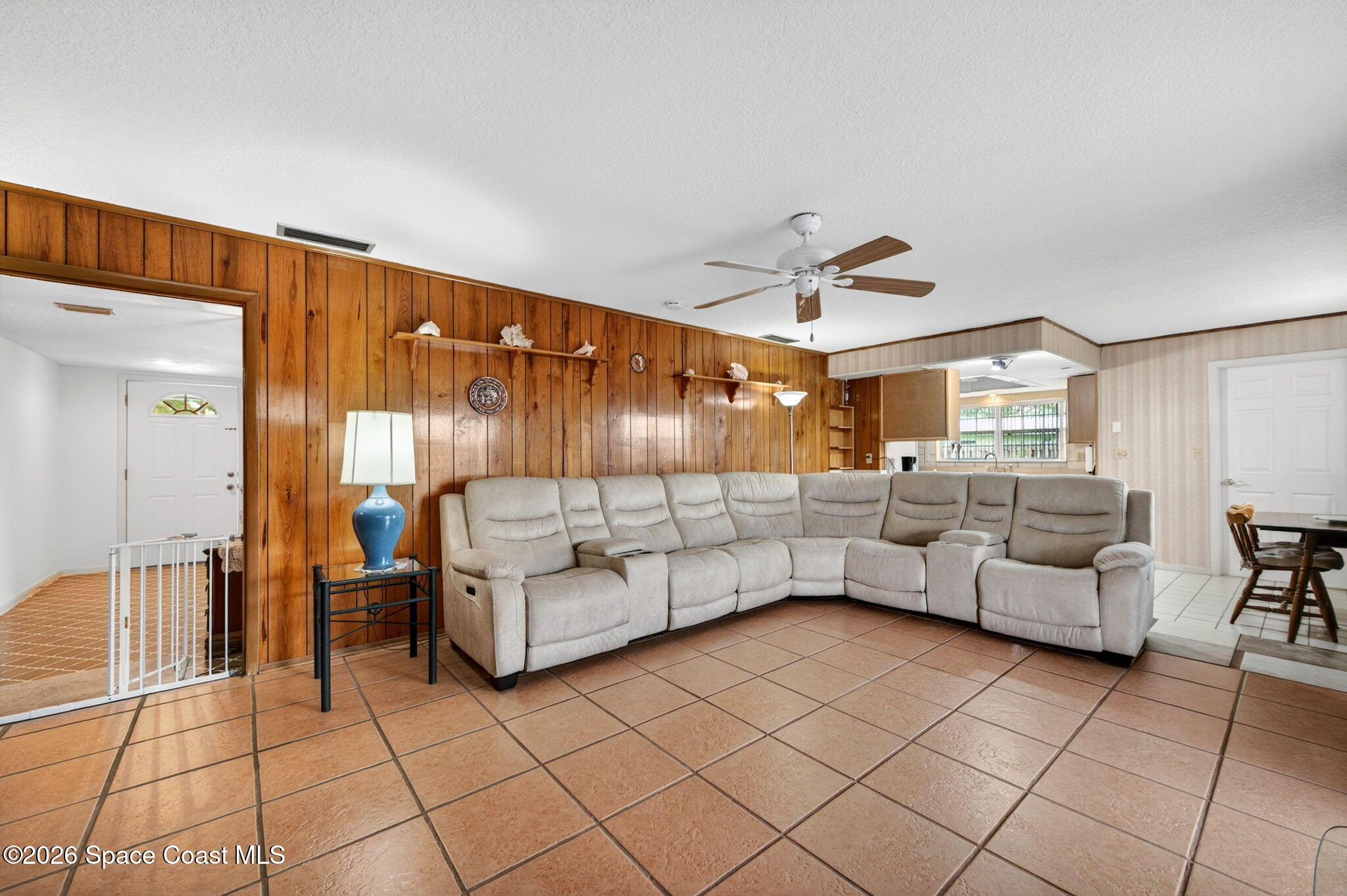 956 Waialae Circle Northeast Palm Bay, FL 32905 - Photo 27 of 45 a living room with furniture and white walls