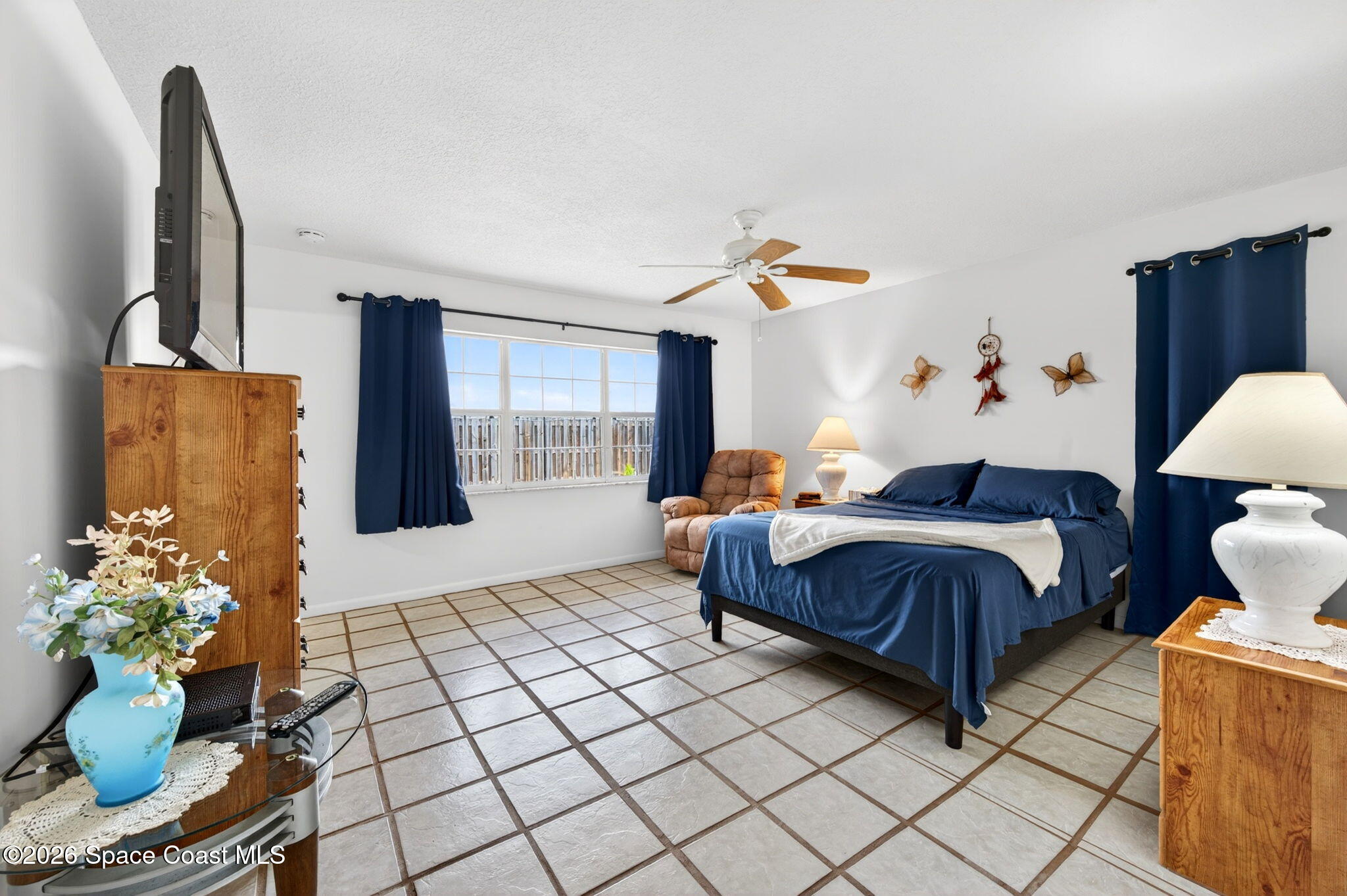 956 Waialae Circle Northeast Palm Bay, FL 32905 - Photo 28 of 45 a bedroom with a bed and a potted plant