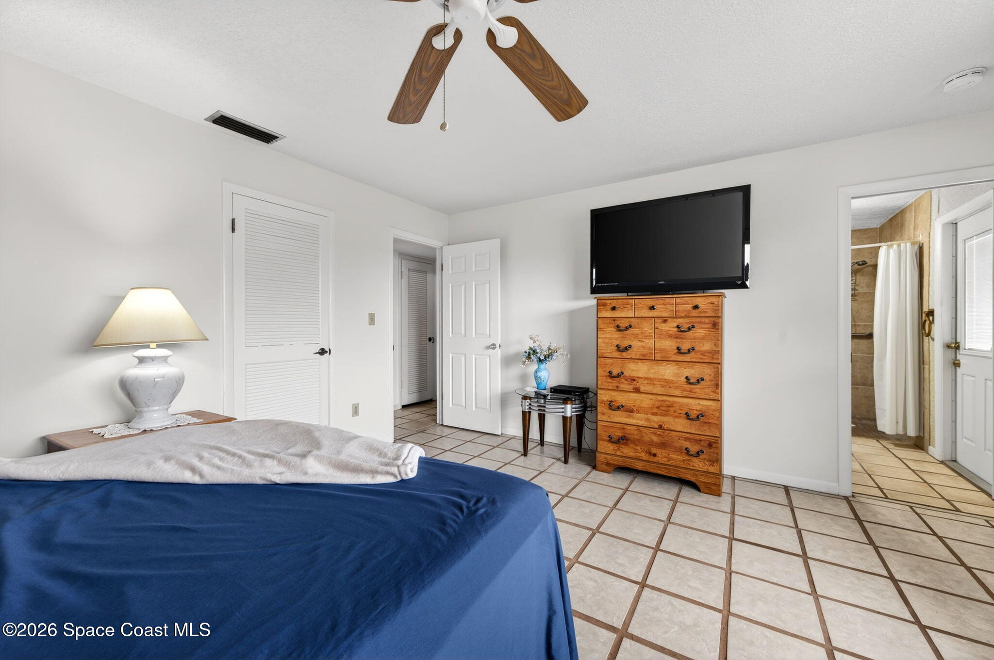 956 Waialae Circle Northeast Palm Bay, FL 32905 - Photo 31 of 45 a bedroom with furniture and wooden floor