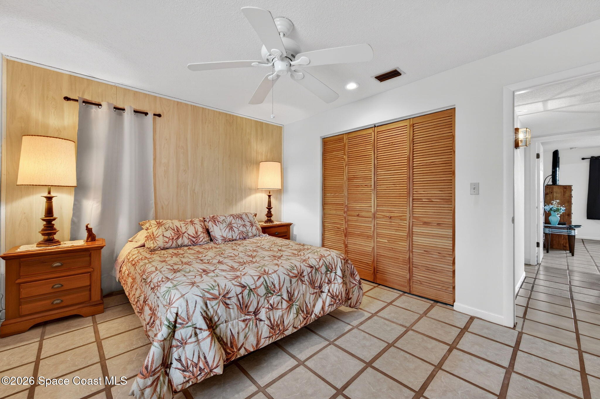 956 Waialae Circle Northeast Palm Bay, FL 32905 - Photo 34 of 45 a bedroom with a bed and a table