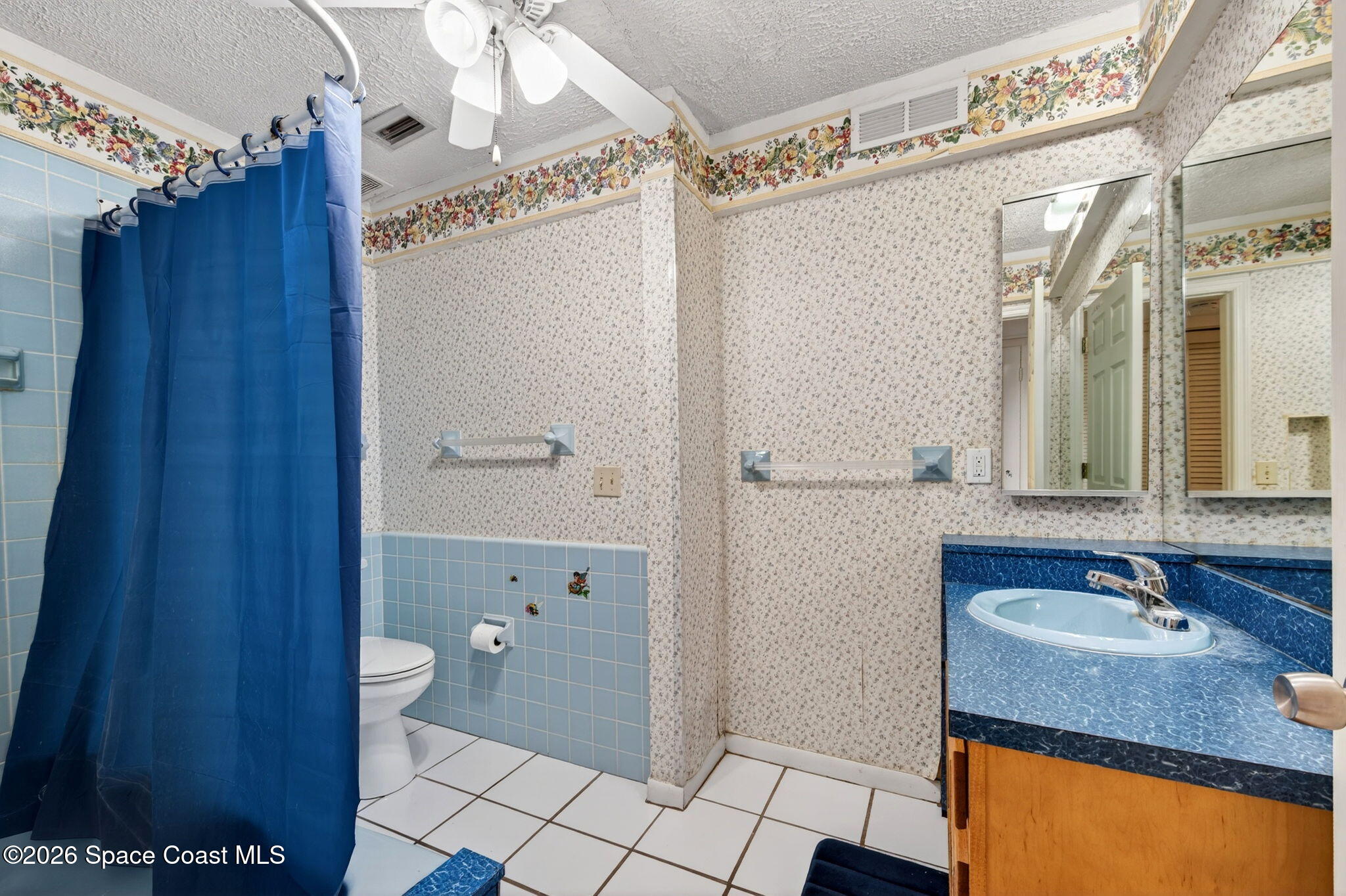 956 Waialae Circle Northeast Palm Bay, FL 32905 - Photo 35 of 45 a bathroom with a granite countertop sink toilet and shower