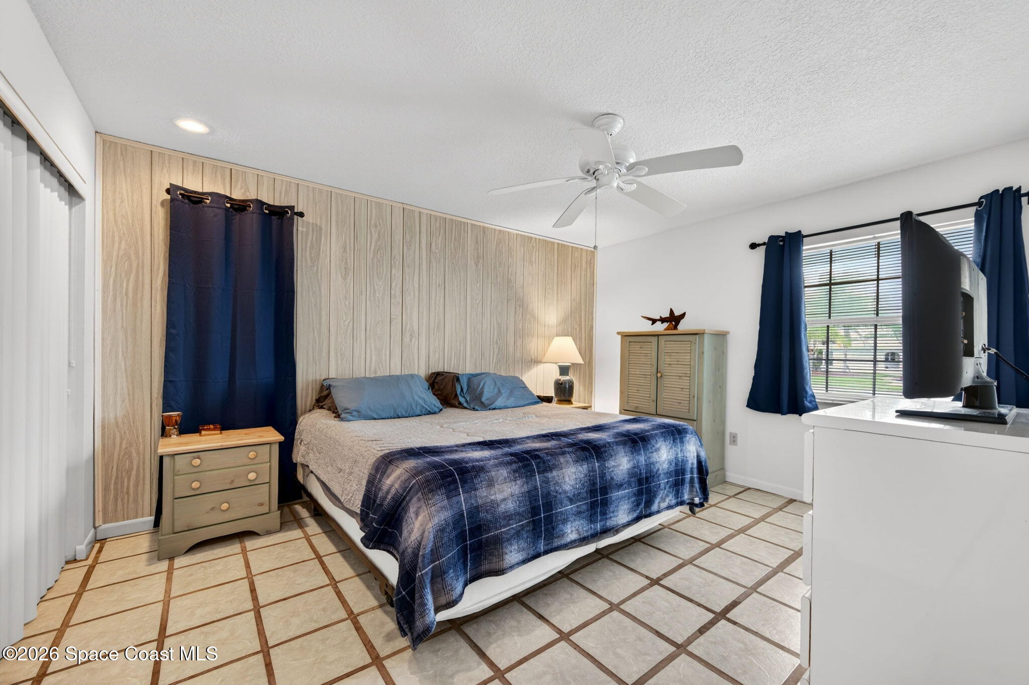 956 Waialae Circle Northeast Palm Bay, FL 32905 - Photo 36 of 45 a bedroom with a bed and window