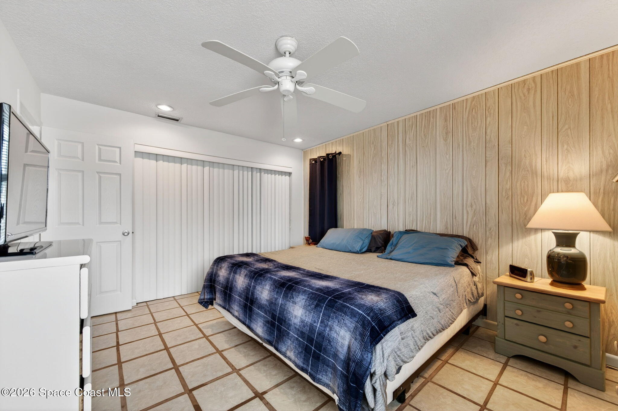 956 Waialae Circle Northeast Palm Bay, FL 32905 - Photo 37 of 45 a bedroom with a bed and a chandelier