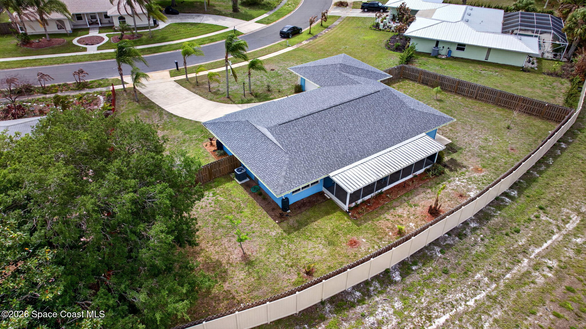 956 Waialae Circle Northeast Palm Bay, FL 32905 - Photo 9 of 45 an aerial view of a house with a garden and yard
