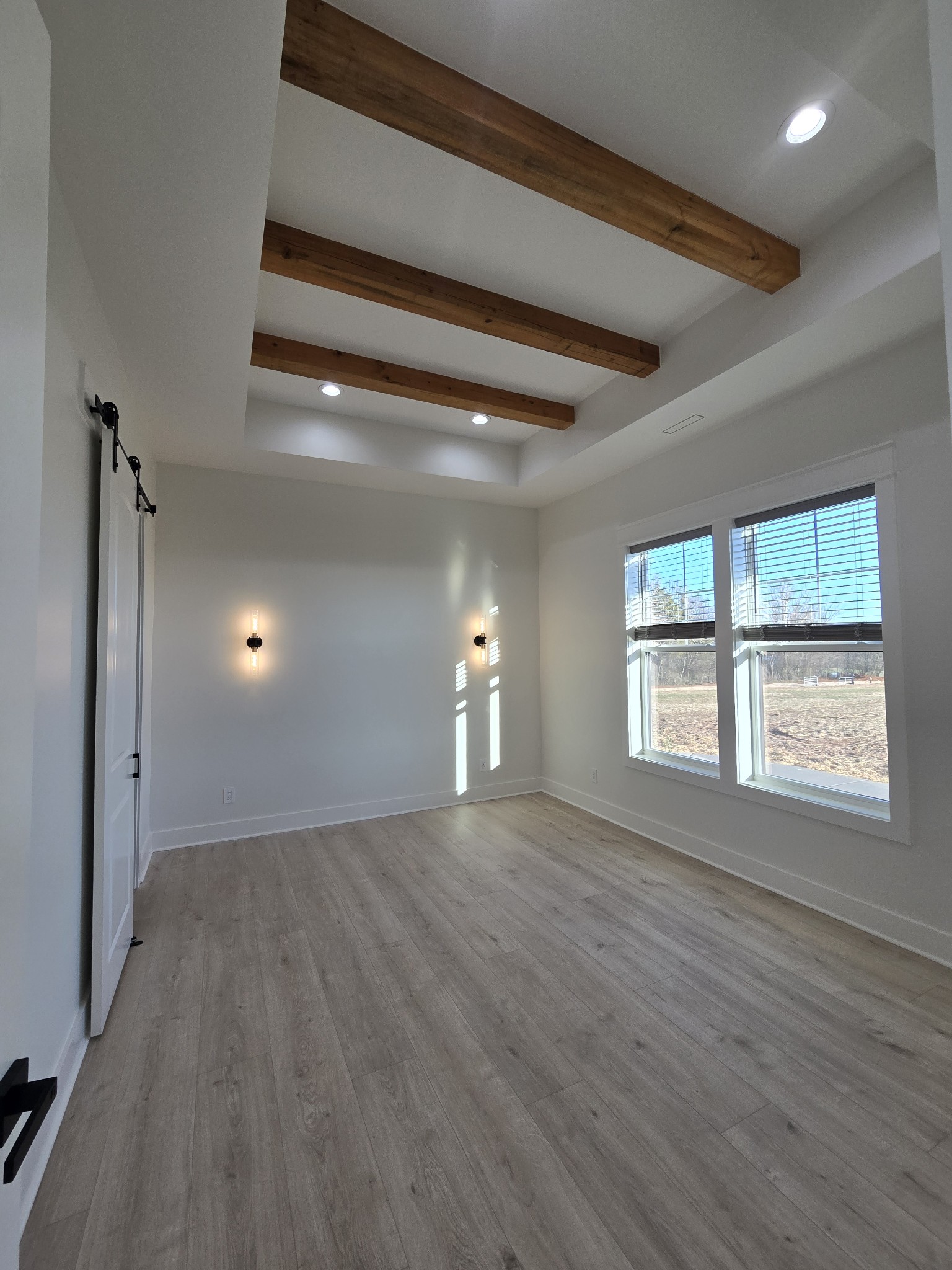 6784 Shelbyville Road Morrison, TN 37357 - Photo 39 of 48 an empty room with wooden floor and windows