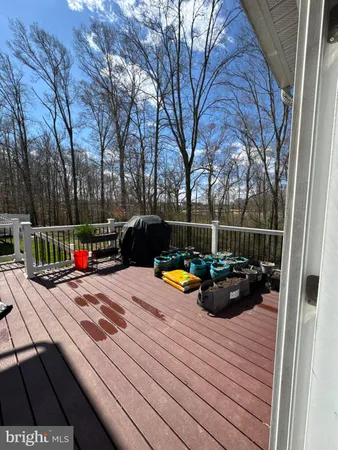 a view of a roof deck with couches and chairs